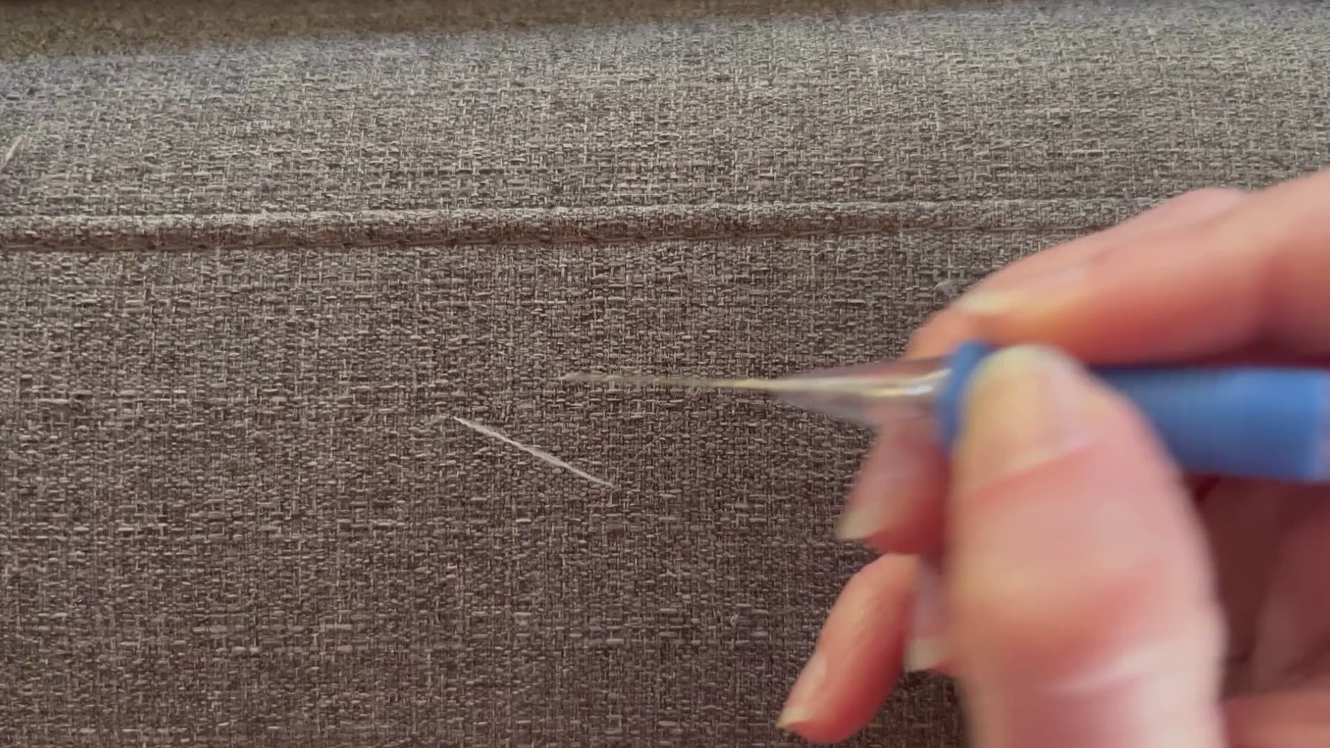 Load video: Video demonstrating how to use a Fabric Fix Stick tool to fix pulls in fabric furniture caused by cats.